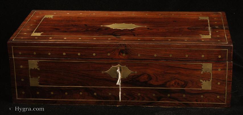 Enlarge Picture: Regency period writing box in brass inlaid figured rosewood with secret drawers concealed behind a sprung panel, and a working Tompson lock.